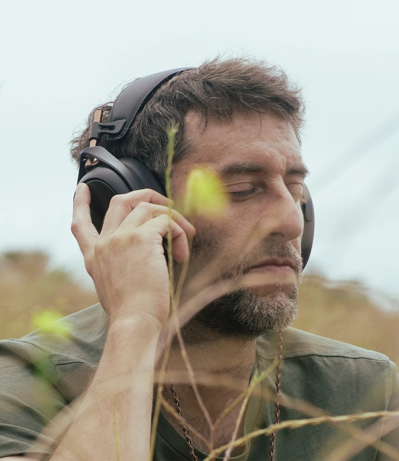 Man listening to Meze Audio Liric premium closed-back planar magnetic headphones