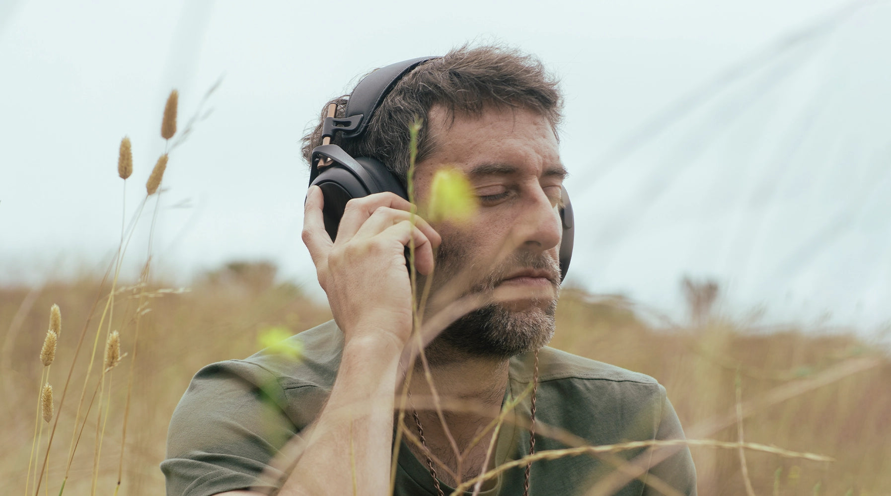 Man listening to Meze Audio Liric premium closed-back planar magnetic headphones