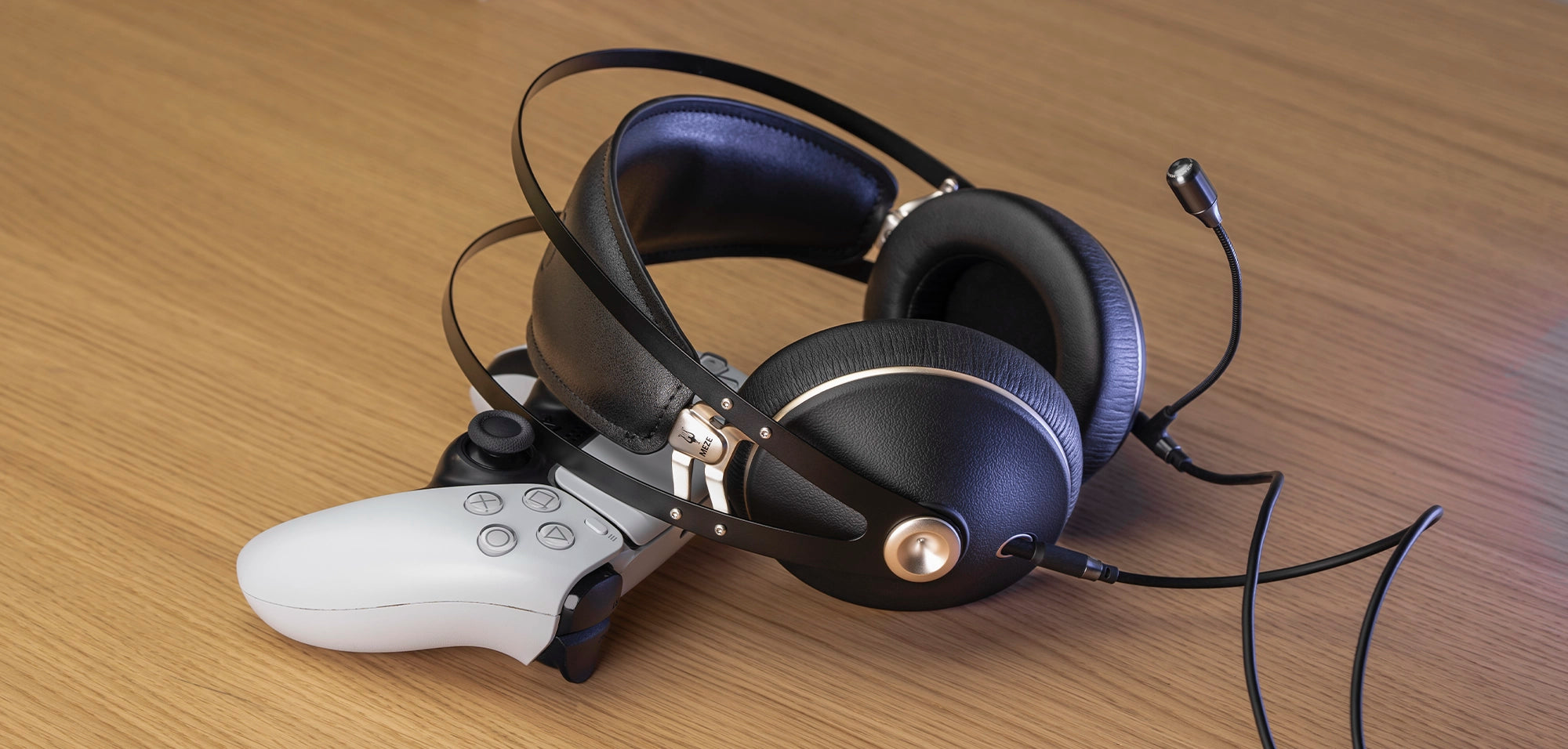 Meze Audio 99 NEO closed-back dynamic driver audiophile gaming PS headset resting on a PS5 controller