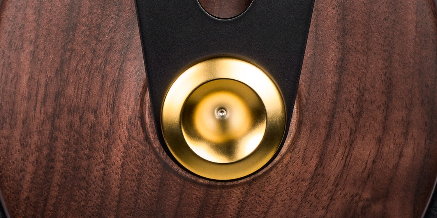 Side view highlighting the sleek walnut wood design and cushioned ear pads for immersive listening.