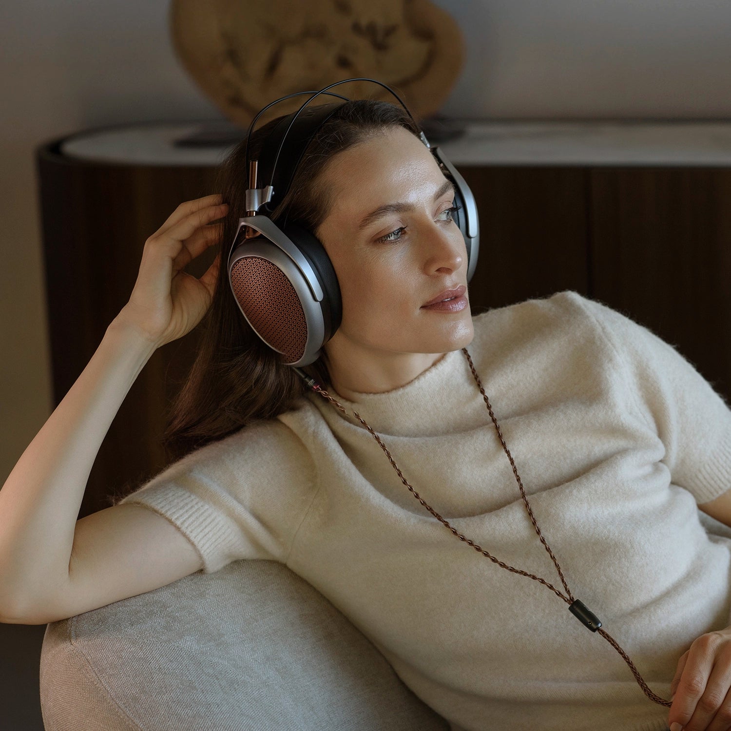 Woman listening to Meze Audio POET premium headphones open-back planar magnetic driver