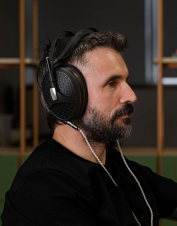 Man wearing the Meze Audio Empyrean II premium hifi open-back planar magnetic headphones