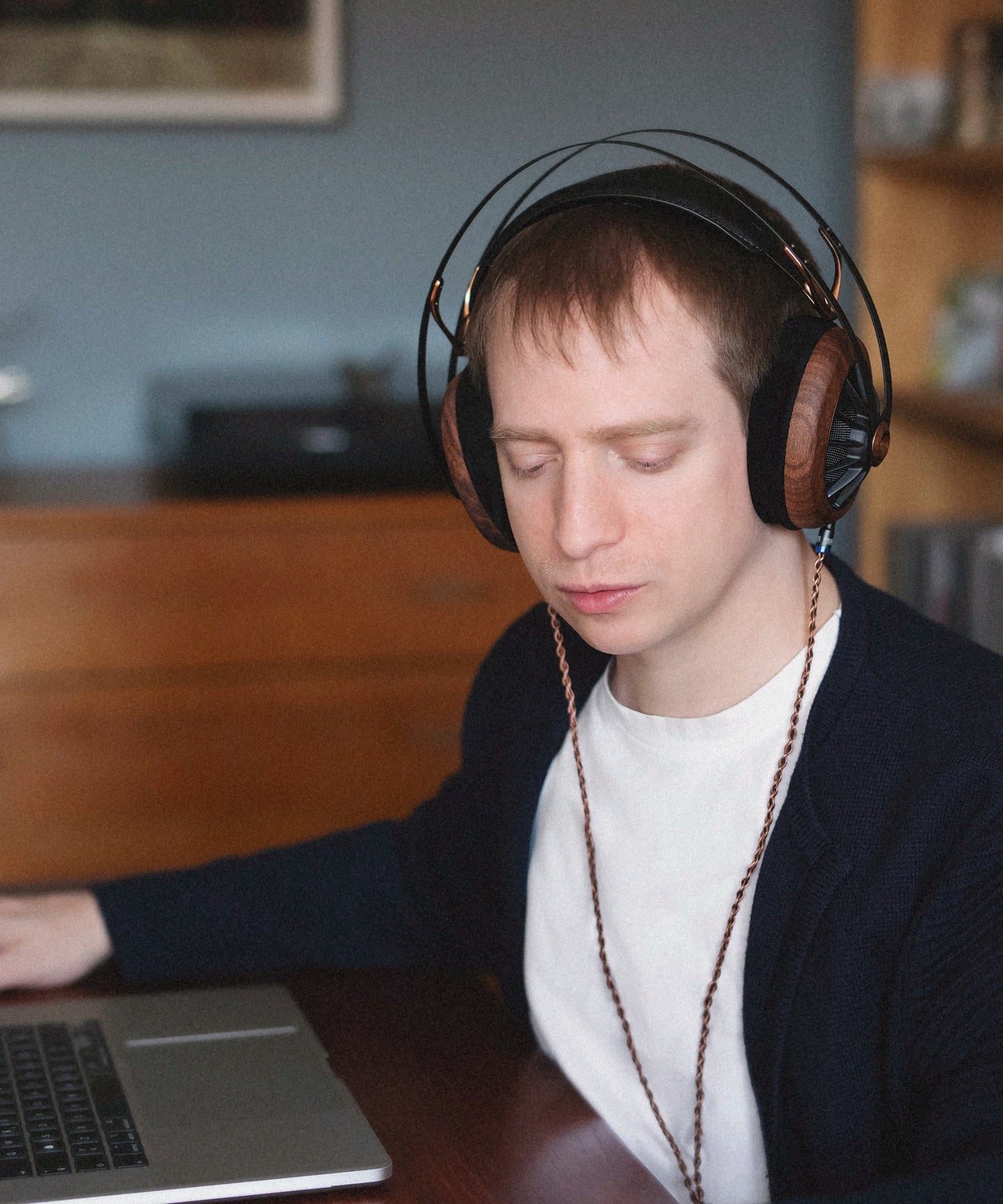 Man working and listening to music on his Meze Audio 109 PRO audiophile open back headphones